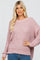 blonde woman wearing a mauve oversized popcorn knit sweater and blue jeans