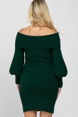 woman wearing a dark green off-the-shoulder ribbed maternity dress with puff sleeves