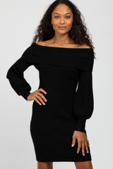 Woman wearing a black off-the-shoulder ribbed knit dress with long puff sleeves