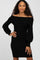 Woman wearing a black off-the-shoulder ribbed knit dress with long puff sleeves