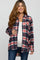 smiling pregnant woman wearing a red and navy blue plaid maternity flannel shirt over a white top