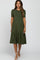 woman wearing an olive green short sleeve maternity dress with a tiered skirt