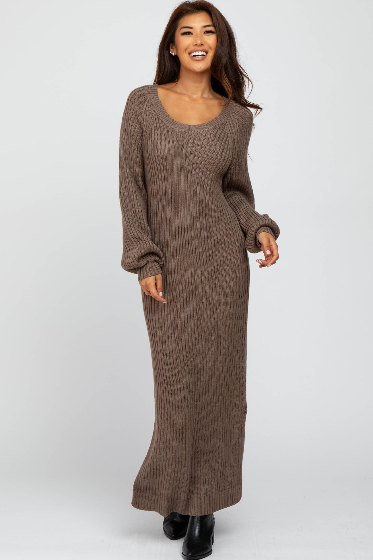 woman wearing a brown ribbed knit maxi dress with long sleeves and a scoop neckline