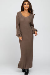 woman wearing a brown ribbed knit maxi dress with long sleeves and a scoop neckline