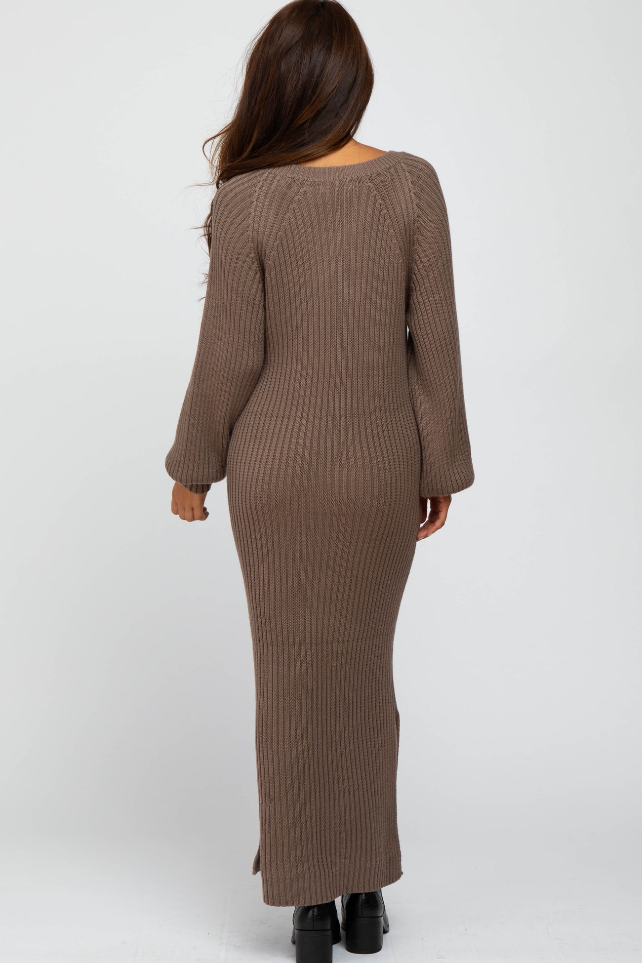 woman from behind wearing a long brown ribbed knit maxi dress with long sleeves