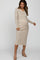 woman wearing a striped beige maternity dress with long sleeves and button details, showcasing her baby bump