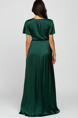 woman wearing a long green satin maxi dress with short sleeves and a cinched waist, viewed from the back