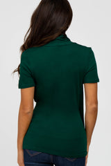 woman wearing a dark green short sleeve polo shirt, shown from the back