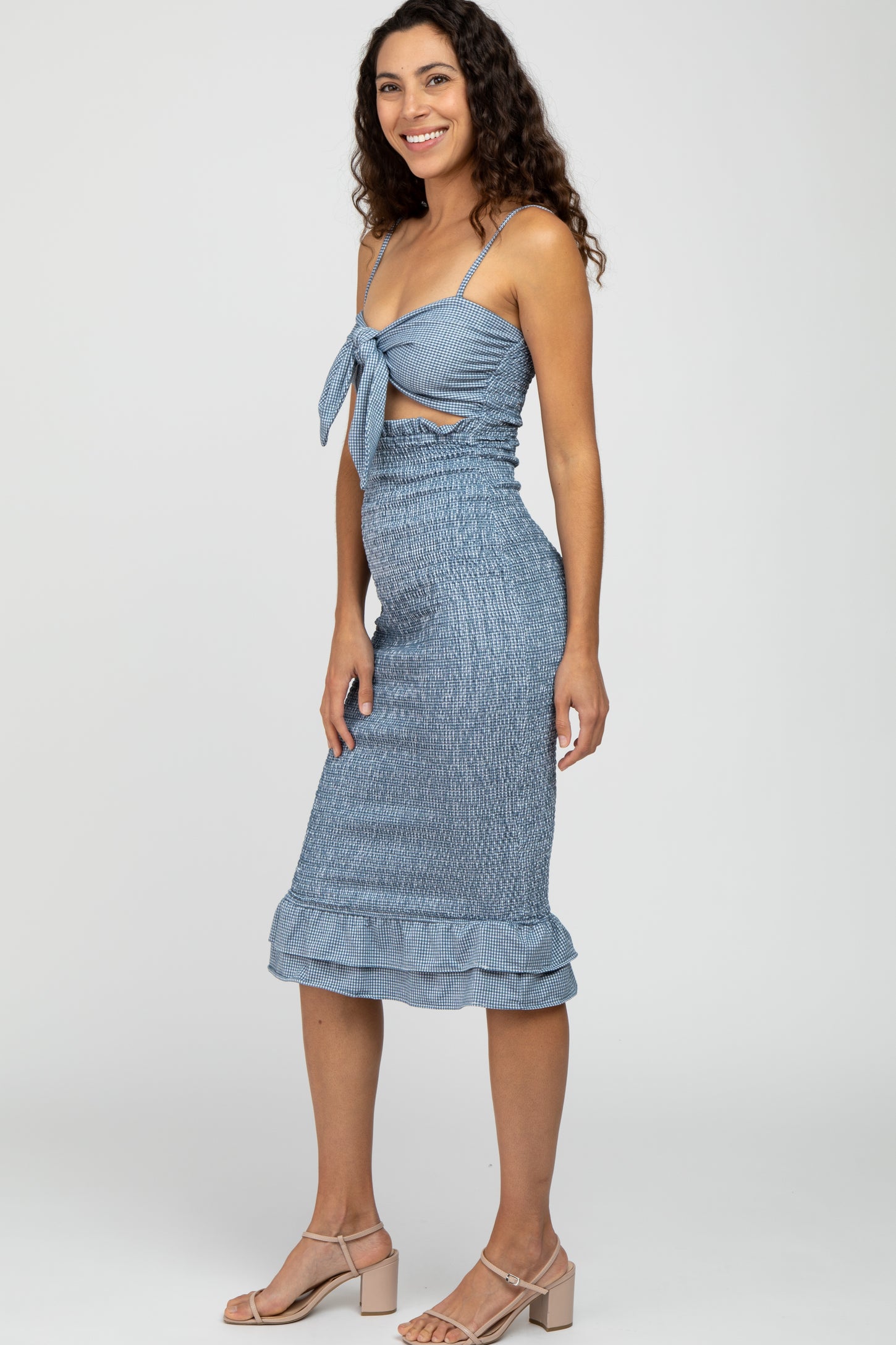 woman wearing blue gingham smocked midi dress with tie front and ruffle hem