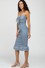 woman wearing blue gingham smocked midi dress with tie front and ruffle hem