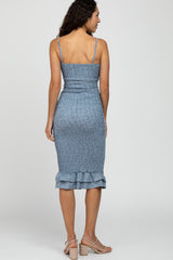 woman wearing a blue smocked midi dress with spaghetti straps and a ruffle hem, viewed from the back