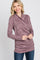 woman wearing a burgundy long sleeve wrap top with a ruched side detail and a casual fit