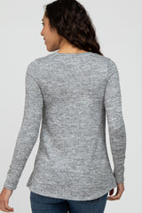woman wearing a gray long sleeve sweater with a slightly curved hem and a relaxed fit, viewed from the back
