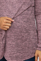 Close up of a woman wearing a mauve marled knit nursing top with a crossover front panel for breastfeeding.