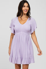 woman wearing a light purple short dress with flutter sleeves and a ruffled hem