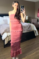 woman taking mirror selfie wearing a pink smocked tiered maxi dress in a bedroom
