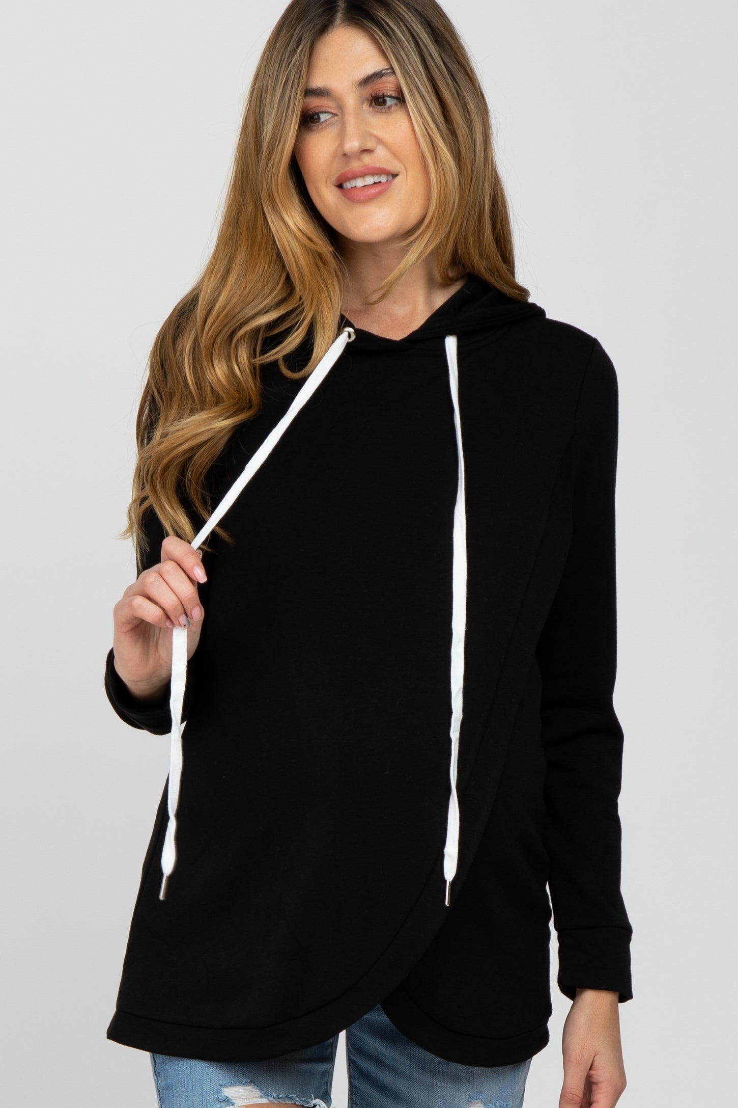 woman wearing a black maternity hoodie with a crossover front and drawstring detail