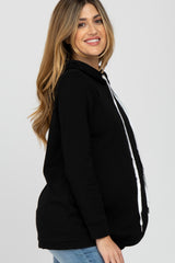woman wearing a black maternity hoodie with zip-up front and drawstring, showcasing her baby bump