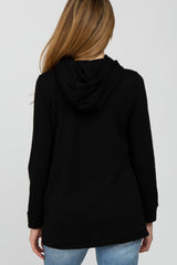 woman wearing a black maternity hoodie with a relaxed fit and a hood, viewed from the back