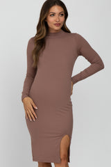 woman wearing a mauve long sleeve ribbed mock neck maternity dress with a side slit