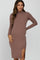 woman wearing a mauve long sleeve ribbed mock neck maternity dress with a side slit