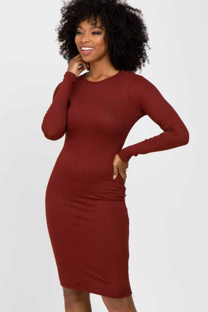 woman wearing a fitted ribbed long sleeve midi dress in burgundy