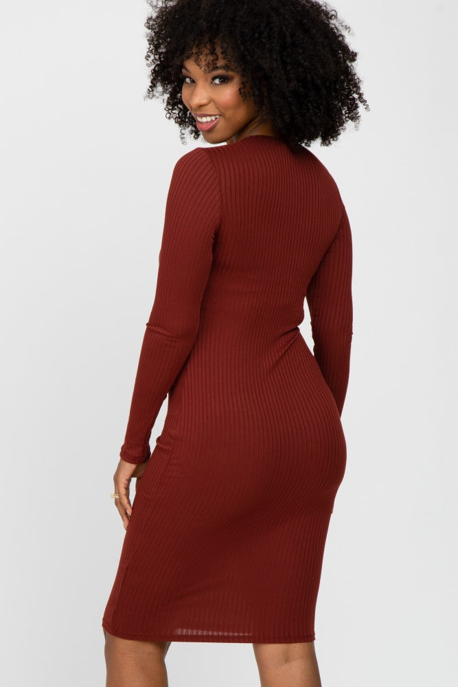woman wearing a fitted rust ribbed midi dress with long sleeves, showcasing a form-fitting silhouette from the back