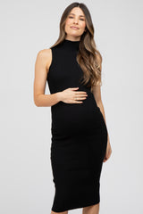 pregnant woman in a black sleeveless mock neck ribbed maternity midi dress holding her baby bump
