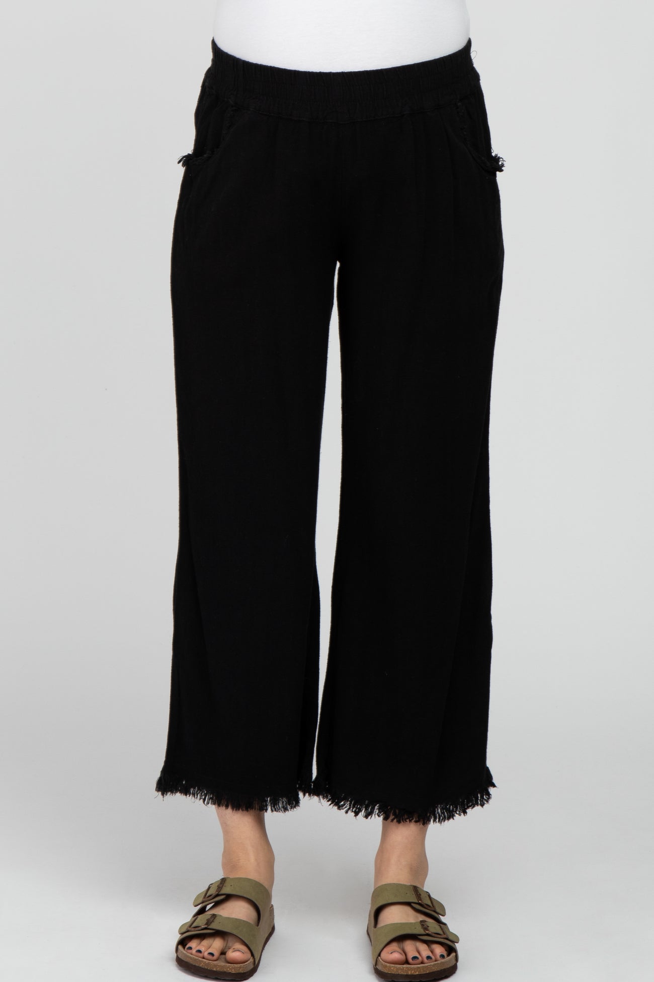 woman wearing black maternity wide-leg pants with fringe hem and side pockets