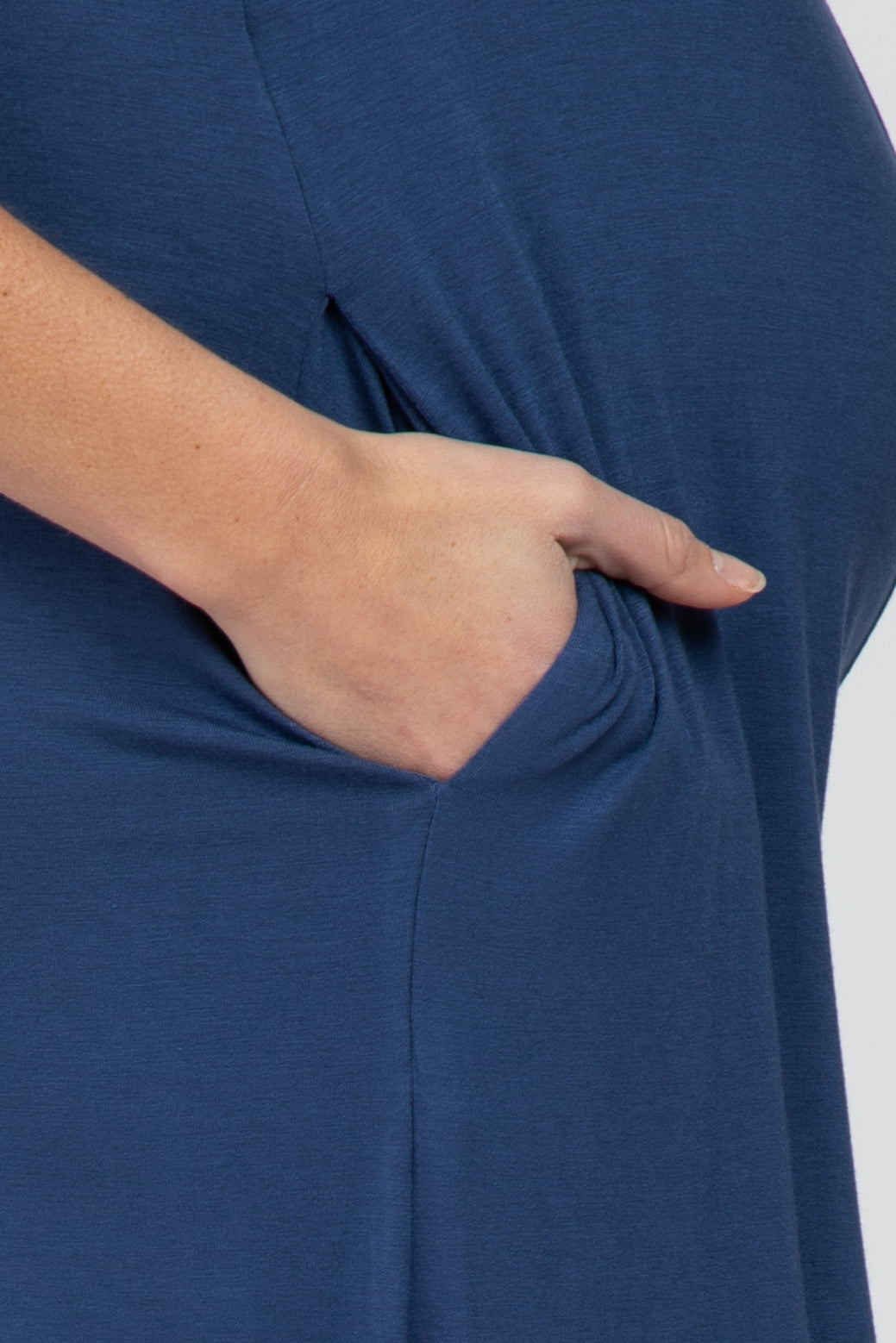 maternity wear in navy blue with a side pocket and a visible baby bump