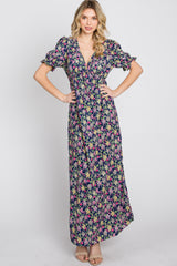 woman wearing a navy blue floral print maxi dress with short puff sleeves and a v-neckline