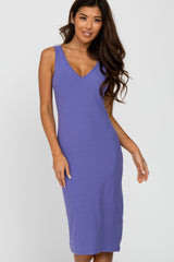 woman wearing a purple ribbed midi dress with a v-neckline and spaghetti straps