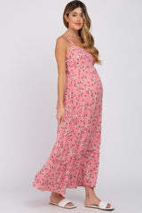 pregnant woman wearing a pink floral maternity maxi dress with spaghetti straps and white sandals