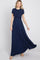 woman wearing a navy blue short sleeve maxi dress with a twisted bodice and flowing skirt