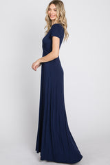 woman wearing a navy blue short sleeve maxi dress with a flowy silhouette