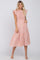 woman wearing a pink floral smocked midi dress with ruffle sleeves and pockets