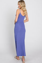 woman wearing a purple ribbed maxi dress with spaghetti straps and a fitted waist, shown from the back