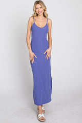 woman wearing a sleeveless purple ribbed maxi dress with a side slit