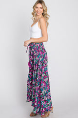 woman wearing white crop top and purple floral wide leg palazzo pants with smocked waist