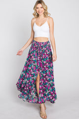 woman wearing white crop top and purple floral maxi skirt with front slit and tassel drawstring