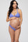 woman wearing a lavender maternity bikini, holding her baby bump with a visible pregnant belly