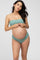 woman wearing a mint green bandeau bikini top and matching bottoms, showing her baby bump