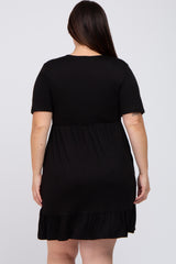woman wearing a black short sleeve plus size dress with a tiered ruffle hem, seen from the back