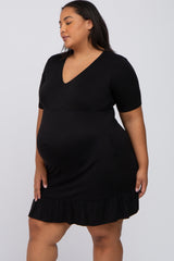 woman wearing a black short sleeve maternity dress with a v-neckline and ruffled hem, showing her baby bump