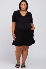 woman wearing a black maternity dress with short sleeves and a ruffled hem, featuring a visible baby bump and pockets