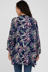 woman wearing a navy floral kimono with bell sleeves and a relaxed fit