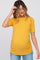 woman wearing a mustard yellow short sleeve maternity top with gathered sides and a visible baby bump