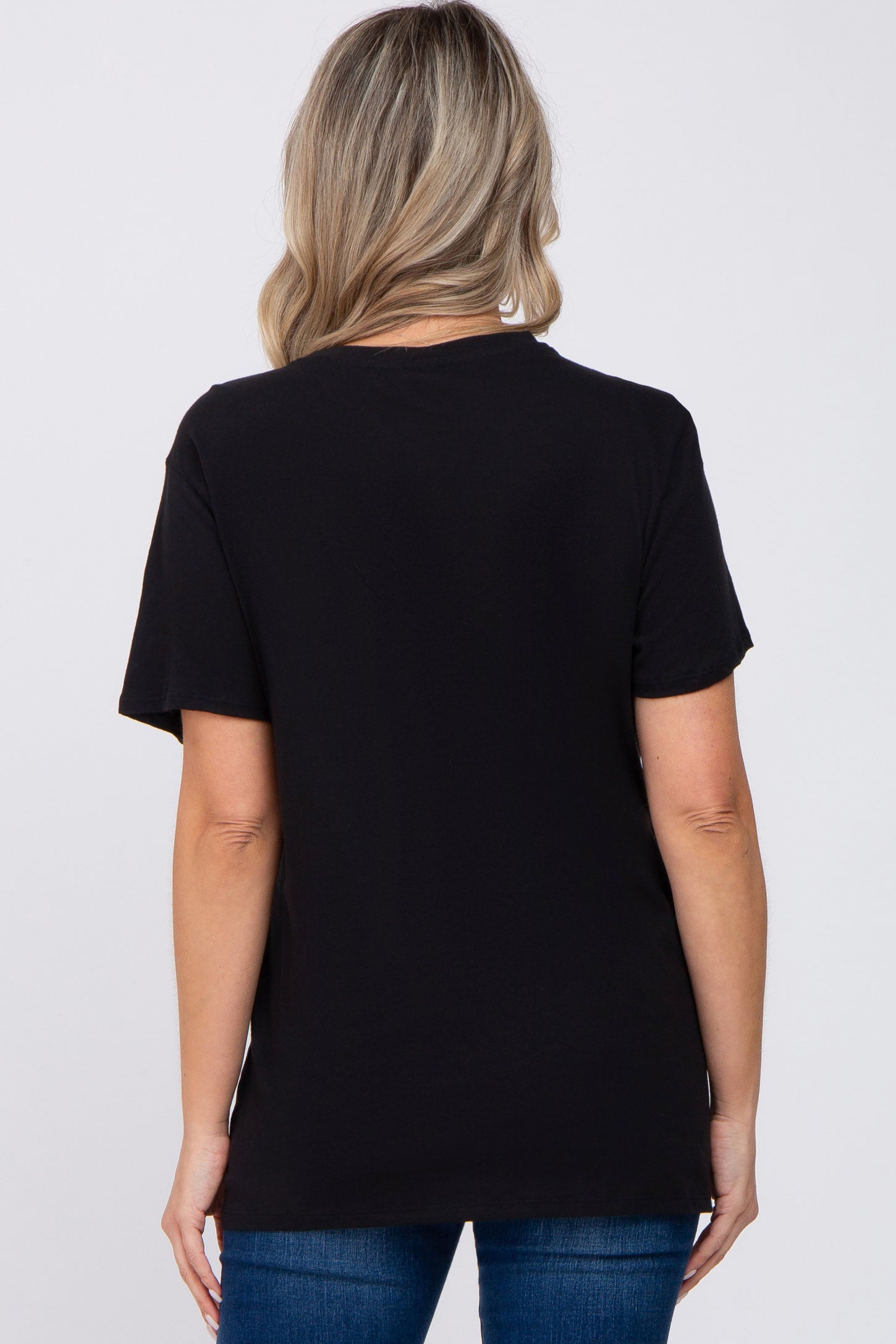 woman wearing a black short sleeve maternity t-shirt, seen from the back with light blue jeans
