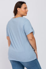woman wearing a light blue short sleeve t-shirt and denim jeans viewed from the back