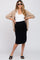 woman wearing a white tank top and a black maternity skirt with a beige shirt, posing with hands on hips and sunglasses
